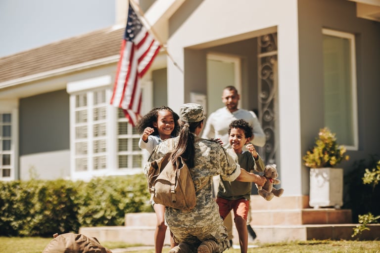 Servicewoman embracing her children after arriving home from the army