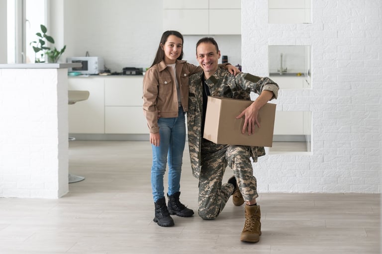 Military parents with daughter hugging, near cardboard boxes