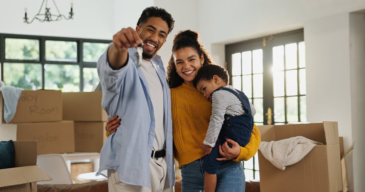Family celebrating their new home with keys